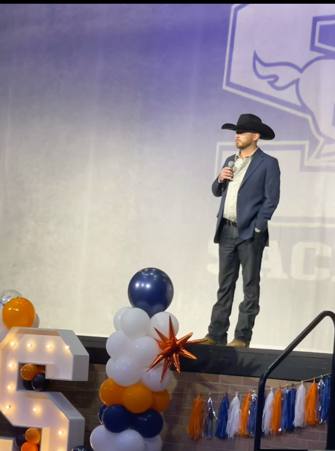 Hayden Burnett speaking onstage at the Sachse High School Senior Brunch